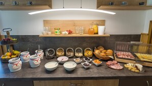 A breakfast buffet with various food items and condiments. - Lauras Country Guesthouse 'Type B Double Room with Balcony' (Medebach)