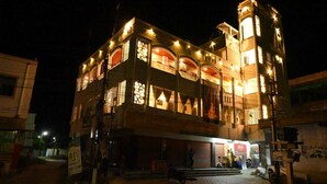 A multi-story building with illuminated windows and balconies at night. - BVR Dazzle Residency (Avanigadda)