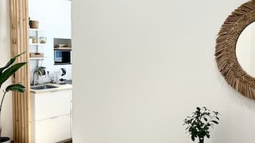 Fridge, microwave, coffee/tea maker, cookware/dishes/utensils