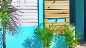 A wall with a wooden slat design and a small sink. - Room-mar Azul - Ocean View Private Studi (Arecibo)