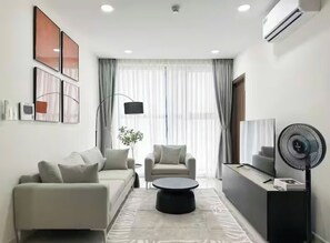 Suite Premier, 2 habitaciones, vista a la ciudad, junto a la alberca | Área de sala de estar | Smart TV de 65 pulgadas con canales premium, chimenea y Netflix