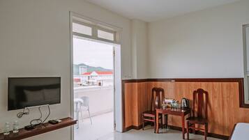 Deluxe Quadruple Room, City View | In-room safe, desk, laptop workspace, blackout curtains