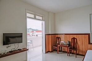 Deluxe Quadruple Room, City View | In-room safe, desk, laptop workspace, blackout drapes