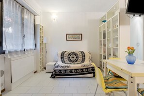 A bedroom with a bed, a desk, a chair, a TV, and a wardrobe. - Apartment 'Cà Daa Richetina' with Private Garden and Wi-Fi (Lerici)