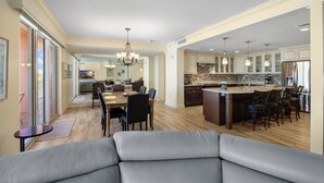 A spacious kitchen with a central island, dining area, and a cozy seating area. - Unforgettable Luxury at Hyatt Clearwater Beach! (Clearwater Beach)
