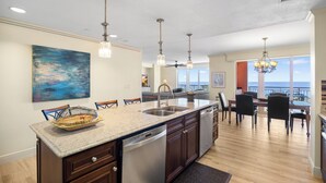 A modern kitchen with granite countertops, stainless steel appliances, and pendant lighting. - Unforgettable Luxury at Hyatt Clearwater Beach! (Clearwater Beach)