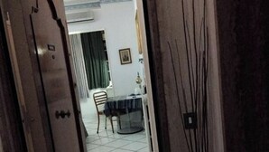 A doorway leading to a dining area with a table and chairs, a tiled floor, and a framed picture on the wall. - BLUE DREAM (Napoli)