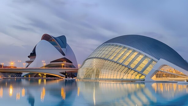 A modern architectural building with a unique curved design, a reflective pool in front, and a bridge connecting to another structure. - Apartment 'Mestalla Flats Rut' with Private Terrace, Wi-Fi and Air Conditioning (Valencia)
