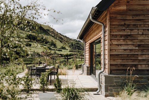 Luxury light-filled oak-framed barn in a peaceful Mid Wales valley, offering panoramic views and generous indoor & outdoor spaces
