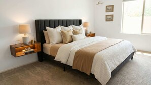 A bedroom with a bed, two bedside tables, a window, and a wall-mounted shelf. - Mid-century Ojai Escape Hot Tub Serene Garden (Ojai)