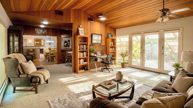 A cozy living room with a fireplace, a dining area, and a workspace with a desk and chair. - Mid-century Ojai Escape Hot Tub Serene Garden (Ojai)