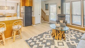A modern kitchen with wooden cabinets, a built-in island, and a refrigerator. - Steps to Sand! Home w/ 3 Decks in Sunset Beach (Sunset Beach)
