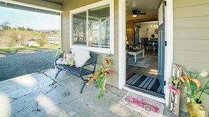 A covered porch with a bench, a welcome mat, and a door leading to an interior with a dining area. - 2 Mi to Clear Lake: Pet-friendly Lakeport Retreat! (Lakeport)