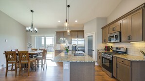 A modern kitchen with granite countertops, stainless steel appliances, and wooden cabinetry. - < 1 Mi to Rio Grande Trails: Quiet Alamosa Escape (Alamosa)