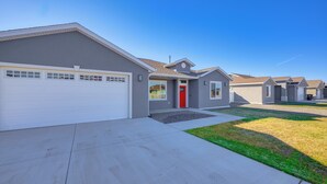 A residential neighborhood with modern houses, a red door, and a well-maintained lawn. - < 1 Mi to Rio Grande Trails: Quiet Alamosa Escape (Alamosa)