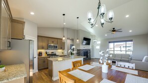 A spacious kitchen with granite countertops, stainless steel appliances, and pendant lighting. - < 1 Mi to Rio Grande Trails: Quiet Alamosa Escape (Alamosa)