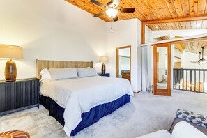 A bedroom with a bed, two bedside lamps, a wooden ceiling, and a view of a balcony. - 1 Mi to Golf Course: Wfh-friendly Pinetop Retreat (Pinetop)