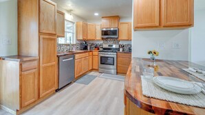 A kitchen with wooden cabinets, stainless steel appliances, and a wooden countertop. - Dog Friendly! Peaceful Wooded Retreat in Prescott (Prescott)