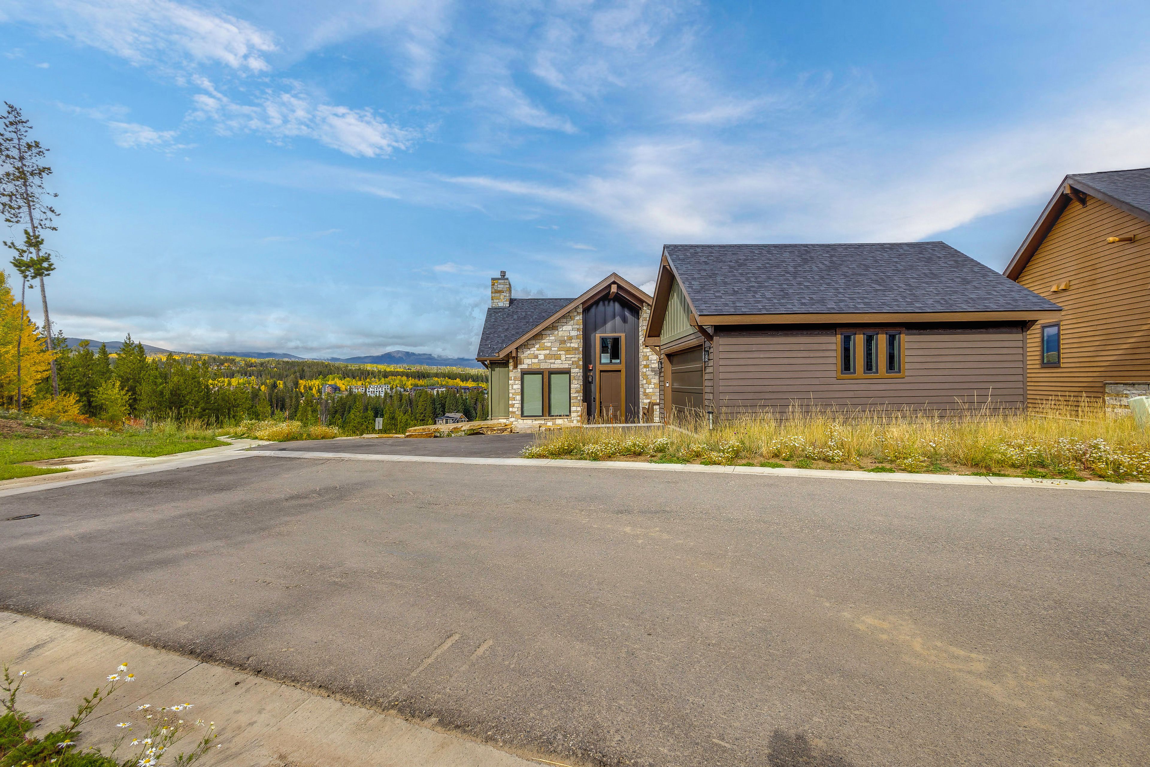 A two-story house with a stone facade and a garage.