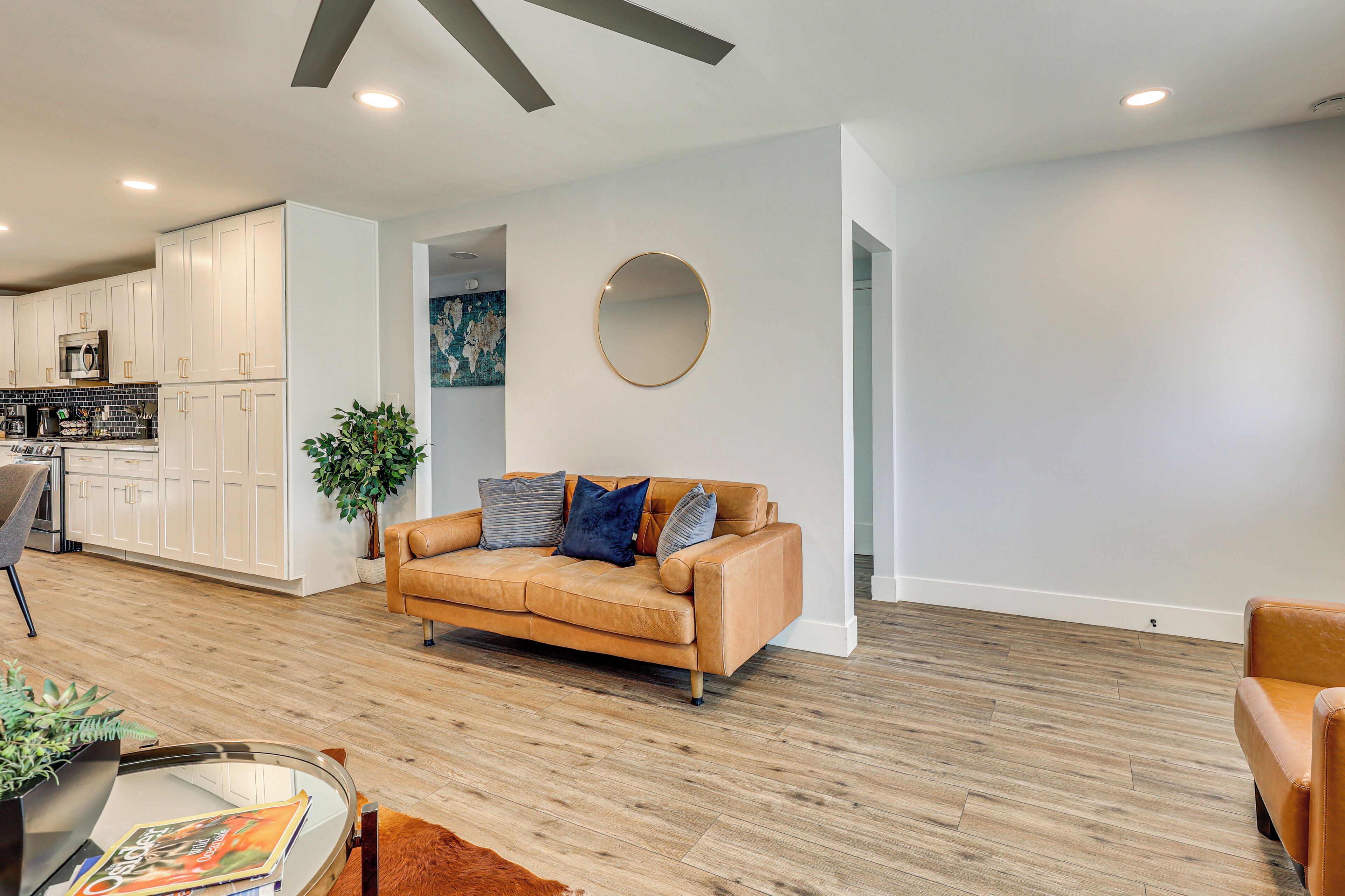 A modern living room with a sofa, a coffee table, and a plant.