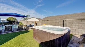 A backyard with a hot tub, artificial grass, a patio with chairs, and a pool. - Private Pool & Hot Tub! Relaxing Mesa Apartment (Mesa)