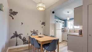 A modern kitchen with white cabinets, a built-in oven, and a sink.
