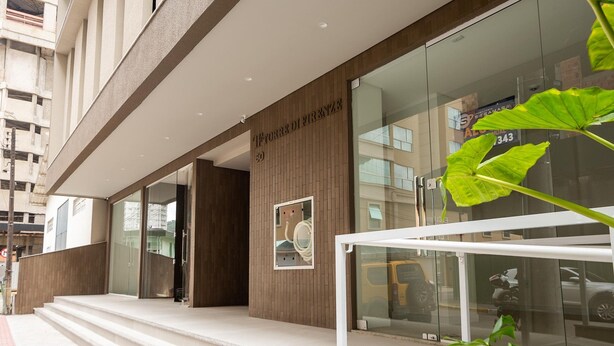 A modern building entrance with a wooden facade, glass doors, and a visible sign. - Apt w/ Barbecue Grill 500m From the Beach Tdf0302 (Itapema)