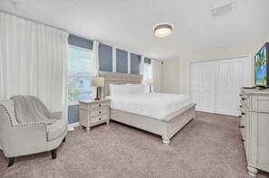 A bedroom with a bed, nightstands, a chair, a dresser, and a television. - Luxury Pool/spa Home With Lots Of Sunshine! 6 Bedroom Villa (Davenport)