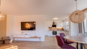 A modern kitchen with white cabinets, a black oven, and a wooden countertop. - House Uhlenhorst WE 2 - Your dog is welcome here - Uhlenhorst 2 - Ihr (Ranzow)