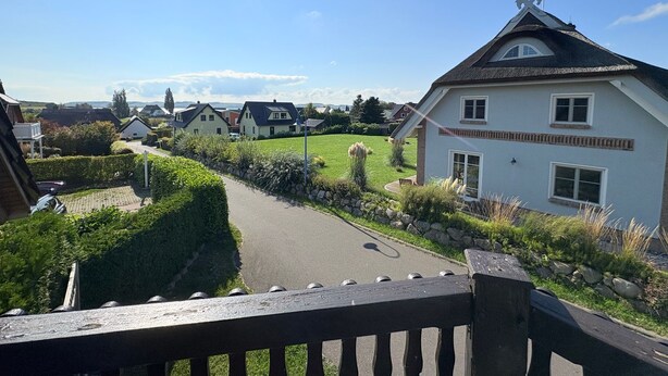 A residential area with houses, a clear sky, and a paved road. - Apartment Seelenfrieden 3 - with balcony for 4 persons - Cozy vacation apartment with balcony (Alt Reddevitz)