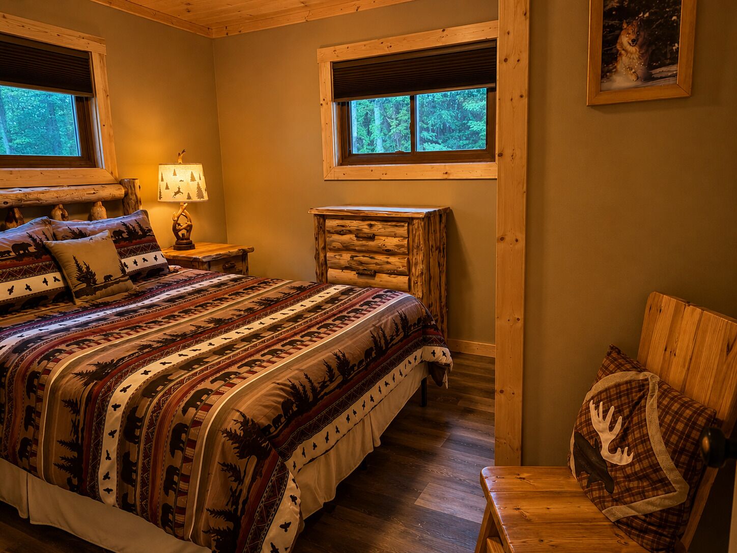 A cozy room with a large bed, two windows, a wooden headboard, and a small table.