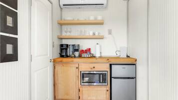 Fridge, microwave, coffee/tea maker, cookware/dishes/utensils