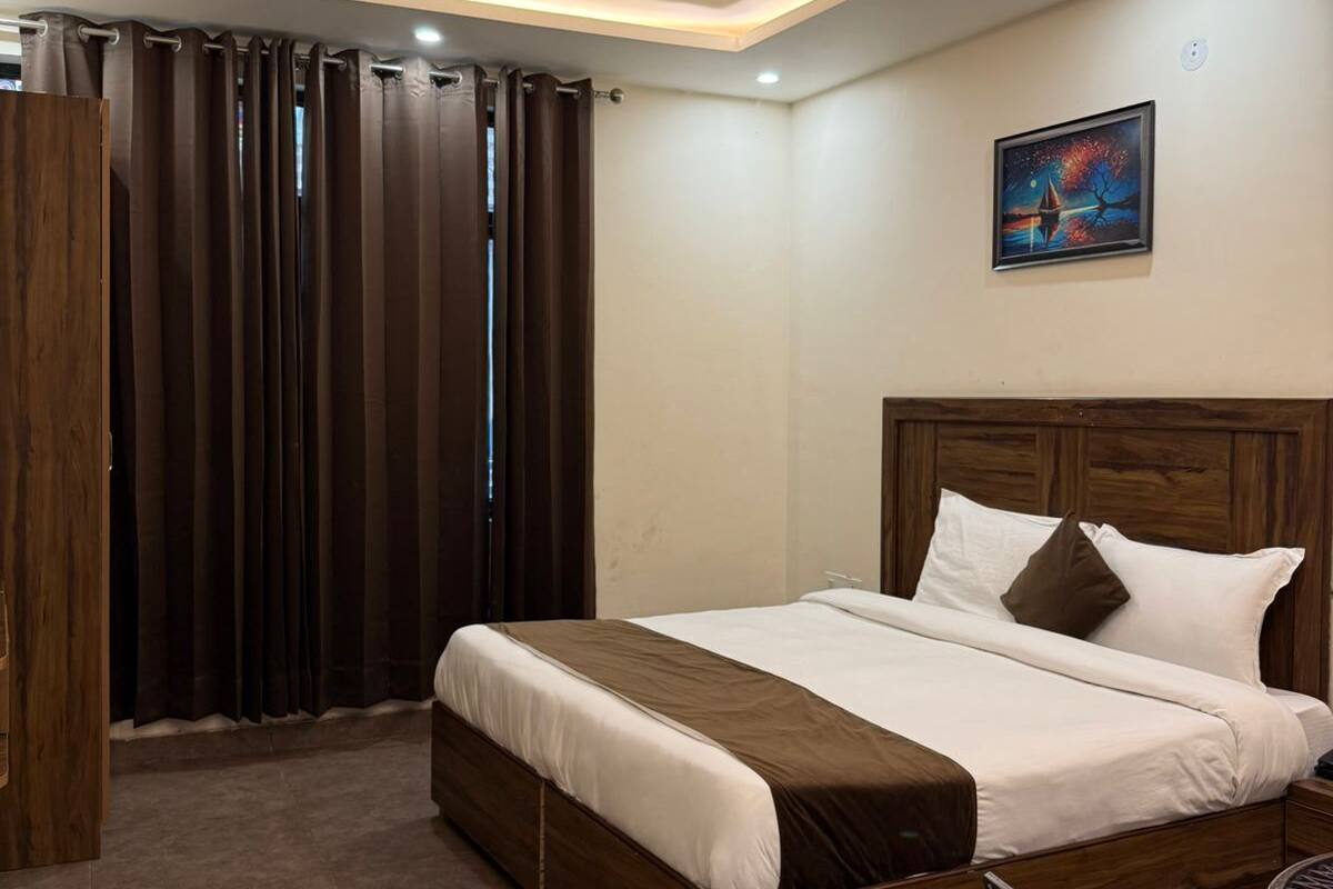 A neatly arranged bedroom with a bed, a ceiling fan, a painting, and a chair.