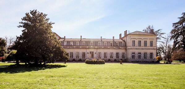 A large, classical building with symmetrical windows and a central courtyard.