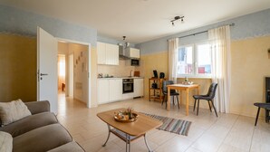 A compact living space with a kitchenette, a dining area, and a seating area.