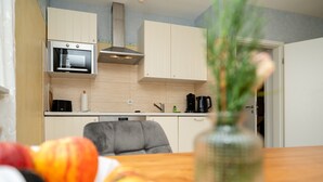 A kitchen with a microwave, oven, and cabinets. - Apartment 'Fewo Cannobio' with Balcony and Wi-Fi (Gengenbach)