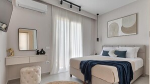 A modern bedroom with a bed, bedside table, mirror, and a large window with curtains. - Villa Luna d'oro (Zakynthos)