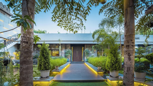 A modern building with a central entrance, surrounded by greenery and illuminated pathways. - The Out House Pushkar (Pushkar)