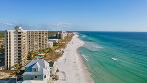 A beachfront hotel with multiple floors, a pool, and a beach view. - Beachfront Comfort | 3BR/3BA | 4th Floor | Quiet East End **BEACH CHAIRS (Panama City Beach)