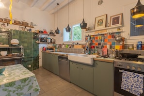 A kitchen with a dishwasher, stove, and various utensils. - Holiday Home "Villa Arja" with Shared Pool, Wi-Fi, and Air Conditioning (Parbayse)
