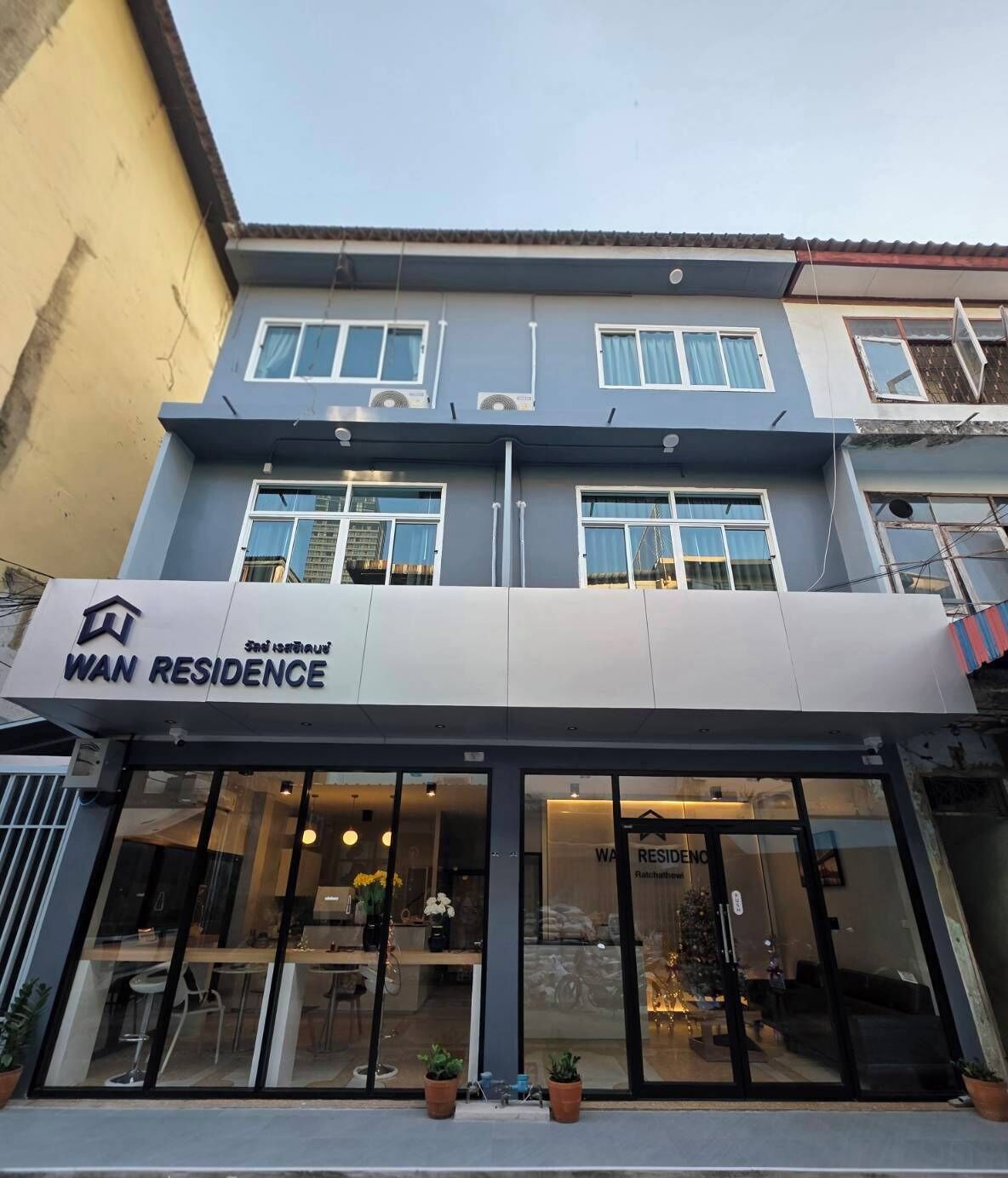 A two-story building with a 'WAN RESIDENCE' sign above the entrance.