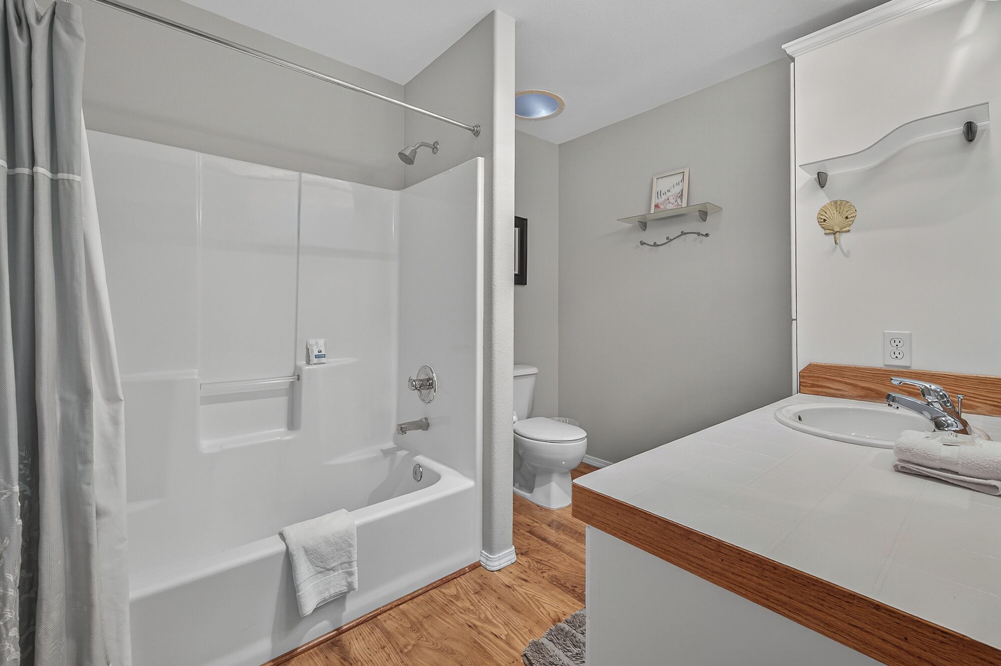 A bathroom with a bathtub, toilet, and sink.