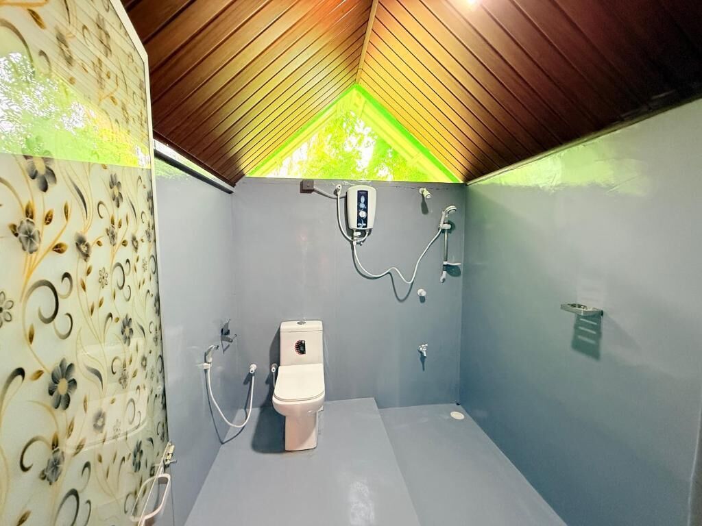 Ein kleines Badezimmer mit Toilette, Dusche und Holzboden.