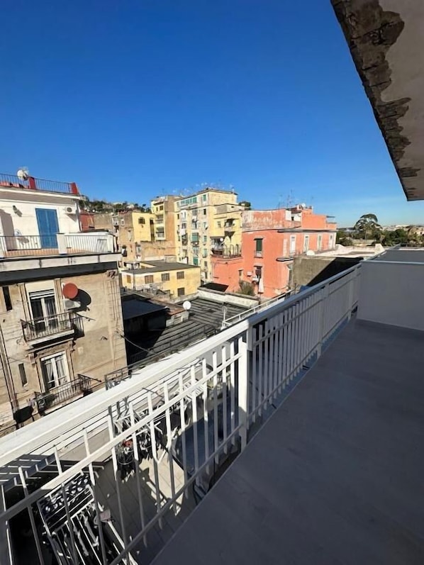 A balcony with a view of a cityscape.
