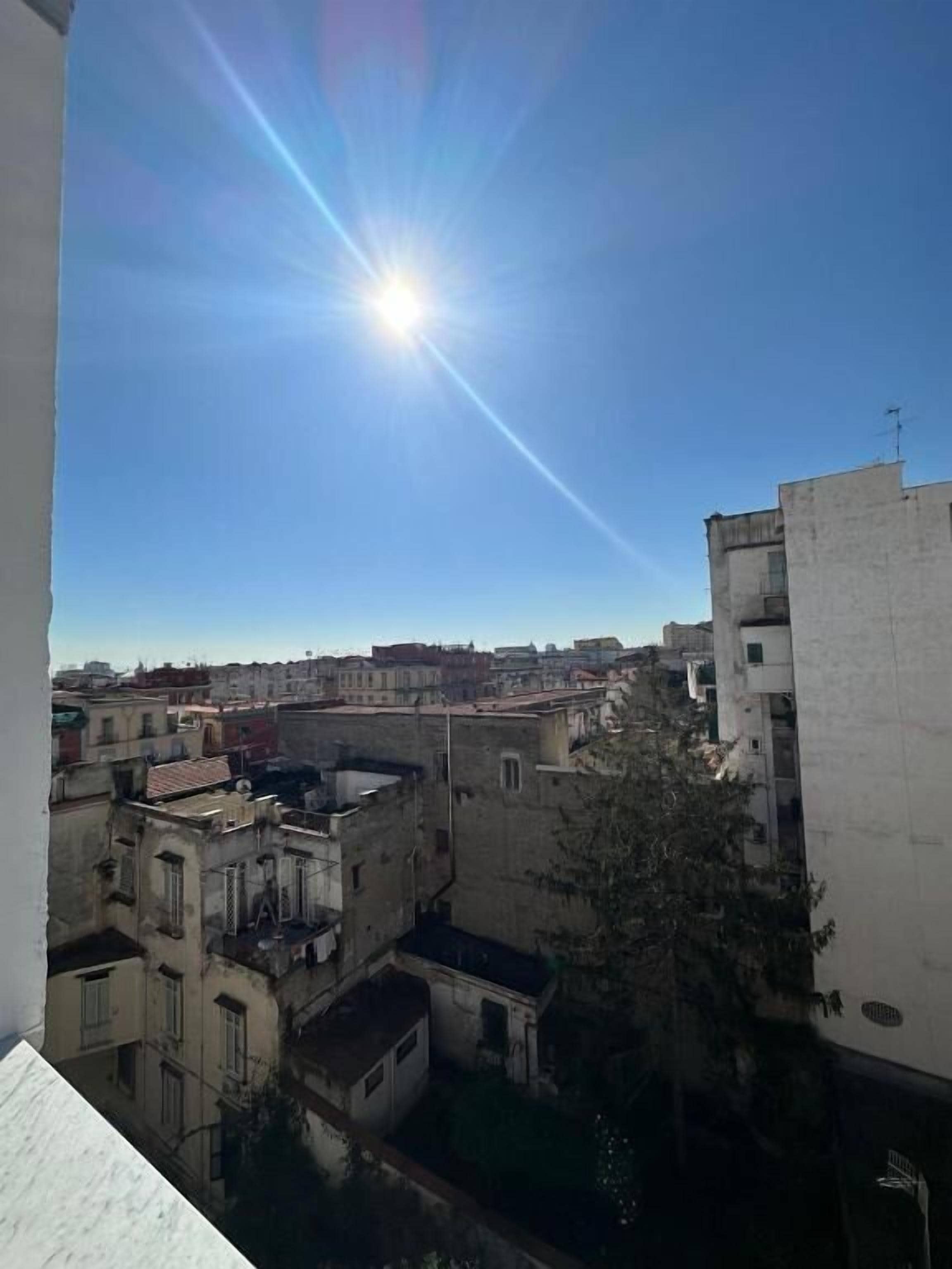 A view of a cityscape with buildings and a clear sky.