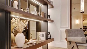A modern interior with a wooden console table, decorative items, and a seating area. - The Lander - 3BR/3BA - Rennes II (Paris)