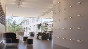 A modern interior with a seating area, a wall with spherical light fixtures, and a view of greenery outside. - Porto Life 2 Luxury Resort by GAV, Porto de Galinhas, Muro Alto Beach, PE (N. São do Ó)