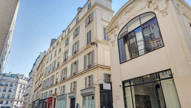 A multi-story building with large windows and a classic architectural style. - French Chic Apartment in Saint Germain #1 (Paris)