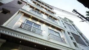 A multi-story building with balconies and windows, featuring a modern architectural style. - Sri Shyam Villas (VARANASI)