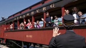 A red train with the word "STRASBURG" on the side. - Boutique Motel in Akron (Akron)